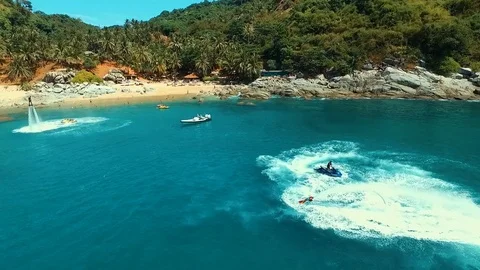 Aerial: Two men doing flyboard on the beach. Stock Footage 70450010