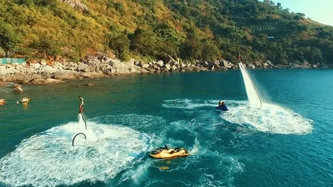 Aerial: Two men flying at sunset on flyboard. Stock Footage 70453121