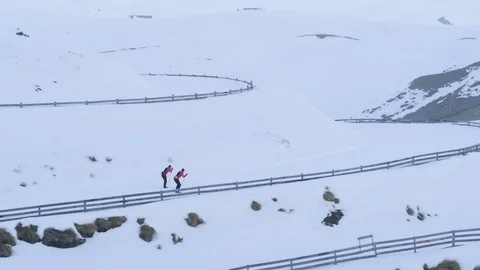 Aerial of two pro athletes cross-country skiing on groomed trails in ski resort Stock Footage 121583252