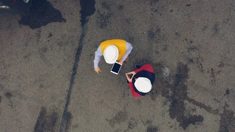 AERIAL. Two workers works on tablet near trucks. Close up Stock Footage 111404932