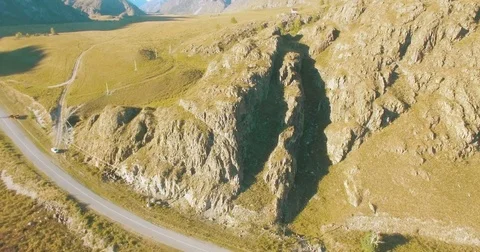 Aerial UHD 4K flight from young hiking man standing on top of the cliff Stock Footage