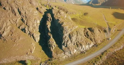Aerial UHD 4K flight from young hiking man standing on top of the cliff Stock Footage
