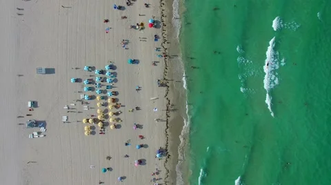 AERIAL - Umbrellas on the beach Stock Footage 65154068