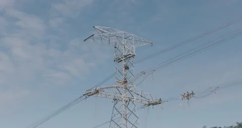 Aerial of unrecognizable workers on overhead powerline wire, maintenance Stock Footage 201238147