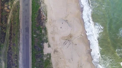 Aerial upside down view of sea coast and road with cars Stock Footage 73813274
