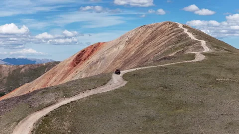 Aerial of UTV side by side vehicle driving Red Cone Peak dirt road in Colorado Vídeo Stock 343154186