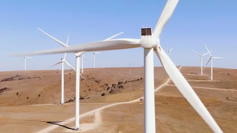 Aerial: various views of large wind turbines in rural areas with high wind. 動画素材 116791848