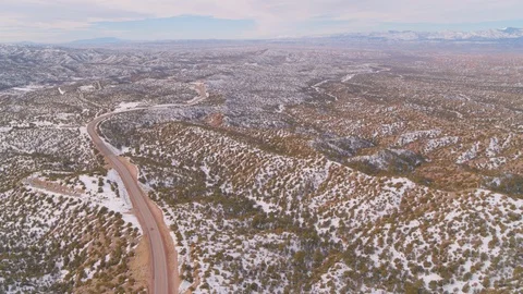 Aerial - Vast mountain range and road - lowering down Stock Footage 101979973
