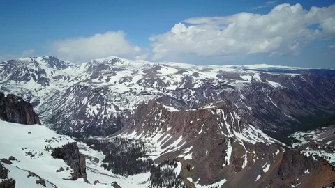 Aerial of vast rocky mountain range covered with snow, winter wilderness Stock Footage 124226486