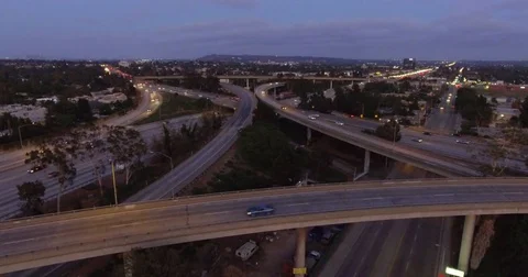 Aerial of vehicles moving on intersecting flyovers at dusk Stock Footage 81532533