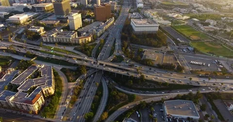 Aerial of vehicles moving on intersecting flyovers and bridges amidst cityscape Stock Footage 81532618