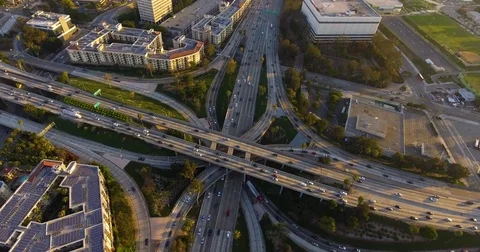 Aerial of vehicles moving on intersecting flyovers and bridges amidst cityscape Stock Footage 81532660