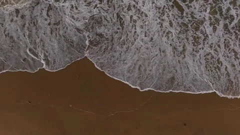 Aerial Vertical Backward Top Down View of Ocean Waves Crashing on a Sandy B.. Stock Footage 339252288