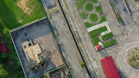 Aerial vertical flyover and around driving training institution next to Stock Footage 276589594