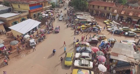 Aerial vertical focus on road junction motorbikes cars in Guinea Africa Stock Footage 82399156