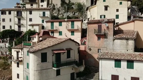 Aerial vertical pan view of Cervara, a medieval village perched on rock spur Stock Footage 92467796