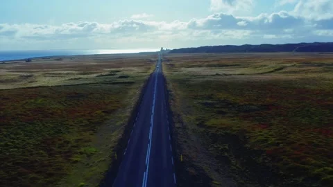 Aerial vertical panoramic view of road, field, ocean and mountain range Stock Footage 168078790