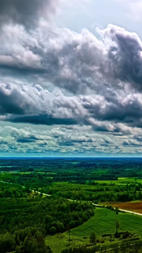 Aerial Vertical Pullback Hyperlapse Over Latvian Forest and Fields Under Video stock 332958737