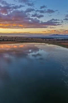 Aerial vertical scene capturing a colourful sunrise over Lake Keepit and th.. Stock Photos