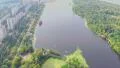 Aerial vertical shot of city park and beautiful wide river HD Footage