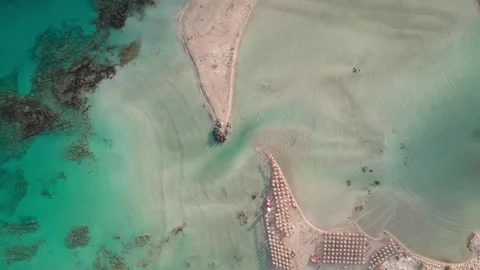 Aerial vertical shot of shallow turquoise sea and exotic beach resort Stock Footage 344547747
