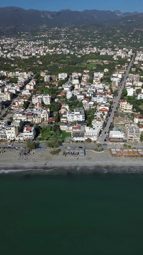 Aerial vertical, slide left dolly shot, cityscape and coastline of Kalamata Stock Footage 332622075