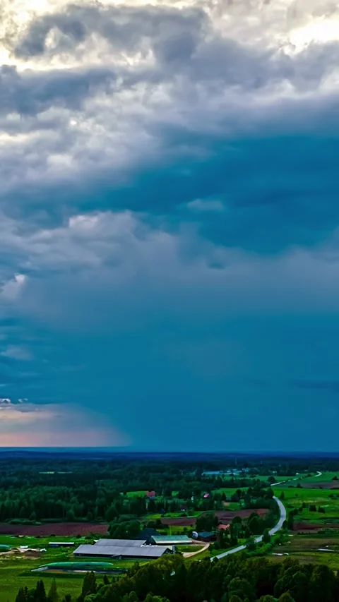 Aerial Vertical Timelapse Of Storm Clouds Moving Over Farm Buildings At Sunset Stock Footage 344922105