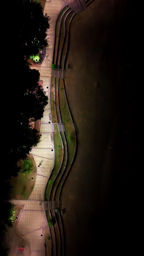 Aerial vertical top down shot looking straight down over a lit lakefront bo.. Vídeos de archivo 339252215