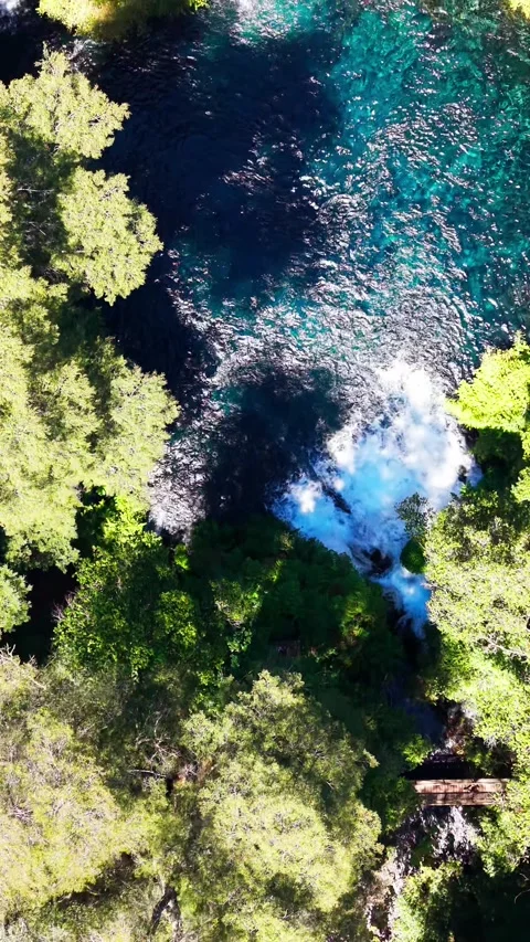Aerial vertical top down tracking shot moving over a clear turquoise river .. Stock Footage 339252201