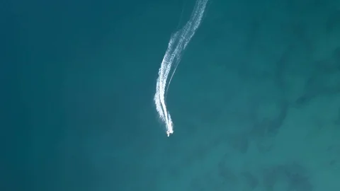 Aerial vertical top down view of a man riding an electric surfboard Stock Footage 93445849