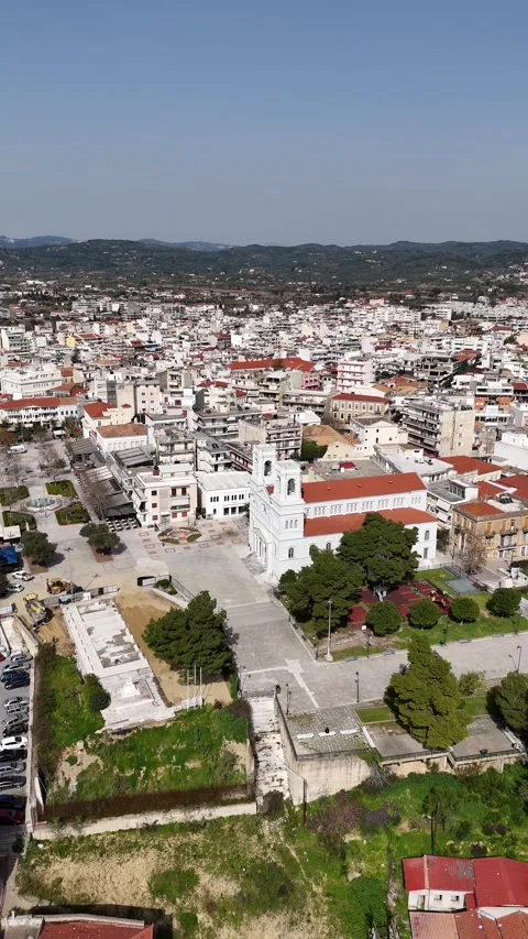 Aerial vertical view of an Agios Nicholas church at the main square of Pyrgos Video stock 304171402