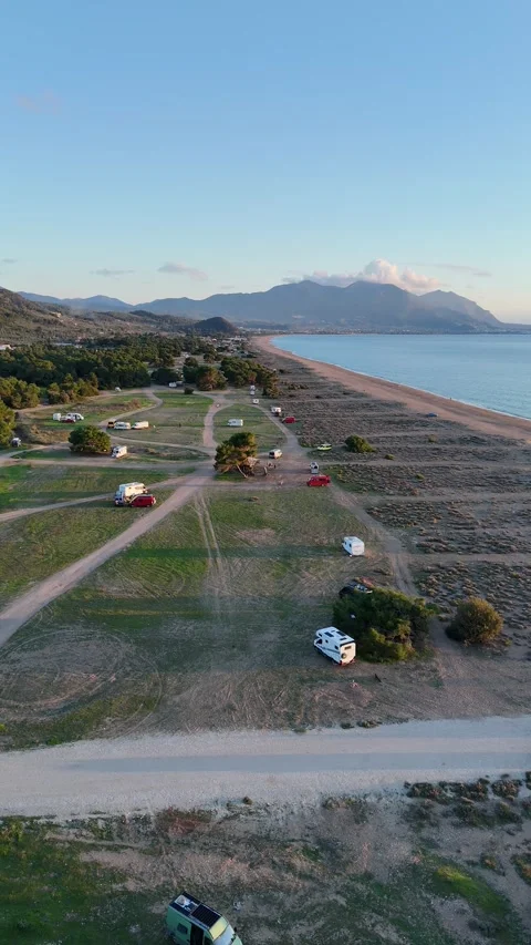 Aerial vertical view of a beautiful sunset at Elea Beach, Greece, a popular camp Stock-Footage 303300538