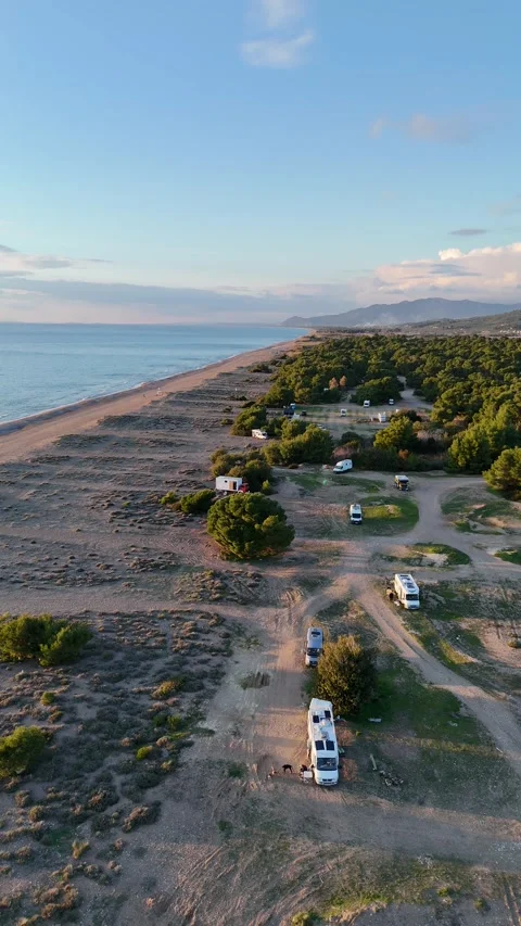 Aerial vertical view of a beautiful sunset at Elea Beach, Greece, a popular camp 스톡 동영상 303301280