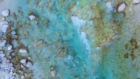 AERIAL vertical view: flight over the surface of a mountain river Stock Footage 87550531