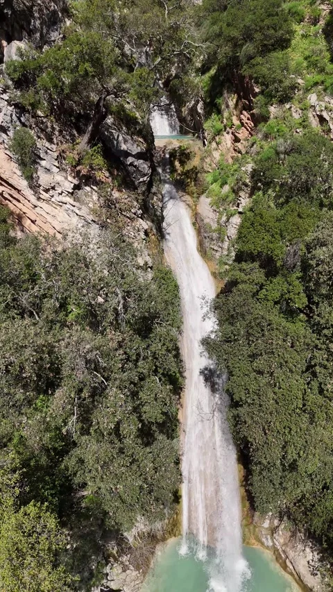 Aerial vertical View of Neda Waterfall and Emerald Pool on a Sunny Day, Greece Video stock 303996850