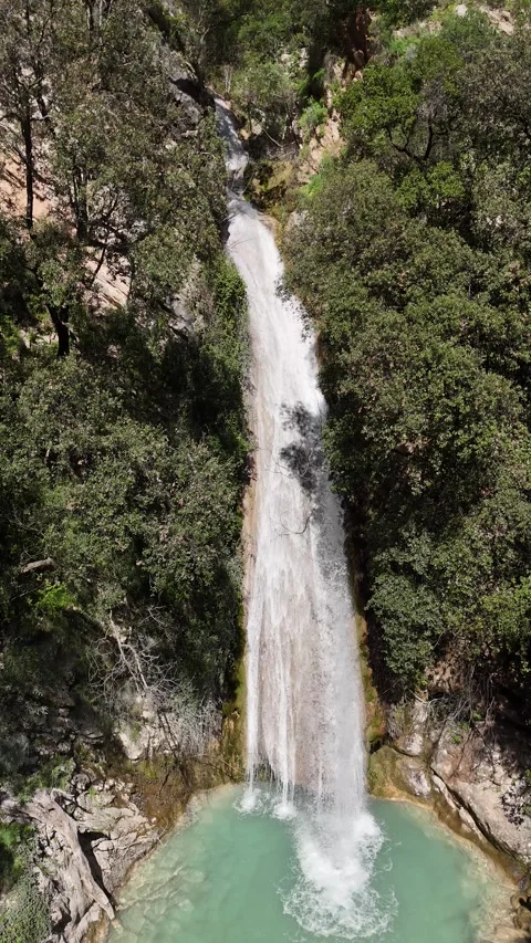 Aerial vertical View of Neda Waterfall and Emerald Pool on a Sunny Day, Greece Video stock 303997818