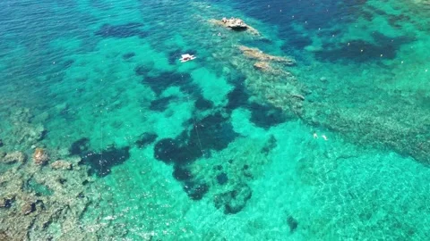 Aerial vertical view of two swimmer Corfù Paleokastritsa beach Stock Footage 167456942