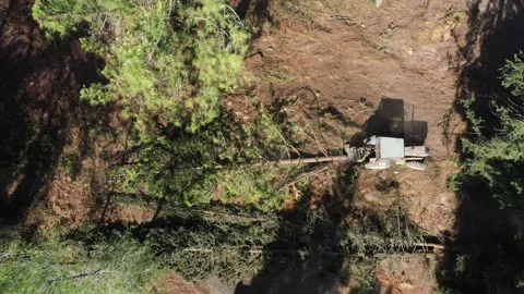 Aerial video above a tactor pulling a tree in Ein Shosfit National Park, Israel Stock Footage 276322970