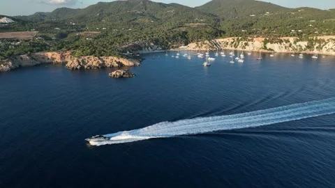 Aerial video beach at sunset. Boats and yachts at anchor. Cala dHort beach. Stock Footage 204032853