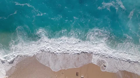 Aerial video of a beautiful empty beach. Waves break on the sandy shore. Stock Footage 229302773