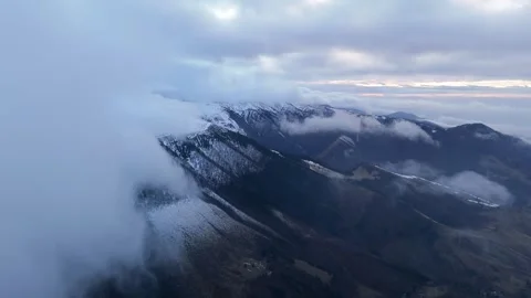 Aerial Video of Clouds Moving Over Winter Mountain Ridge 動画素材 326203379