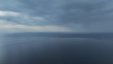 Aerial Video : Cloudy Sunset Over the Sea with Warm Light and Golden Reflections Stock Footage 301005479
