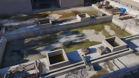 Aerial Video of a Construction Site With Stacks of Bricks, Steel Pipes, and Stock Footage 301365331