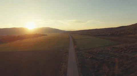 AERIAL video on a country road at sunrise Stock Footage