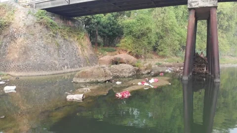 Aerial video of dirty river with plastic trash and domestic waste under the  Stock Footage 158464553