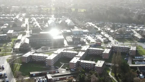 Aerial video of a double deck bus travelling past houses and apartments in Stock Footage 171671831