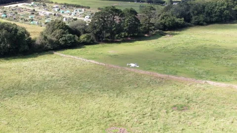Aerial video from a drone of another drone seen hovering directly from above Stock Footage 159652708