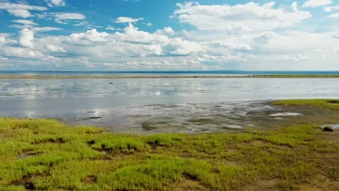 Aerial video from a drone, backing up at low altitude, above the water, at .. Stock-Footage 236338603