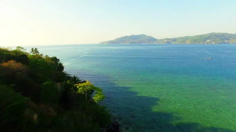 Aerial Video with the drone. The camera runs along an island in the ocean. N. Stock Footage 63127077