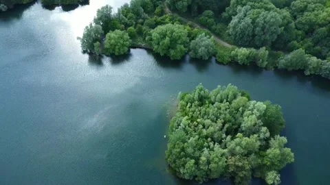 Aerial video of drone flying backwards over lake showing nature and industrial Stock Footage 201747352
